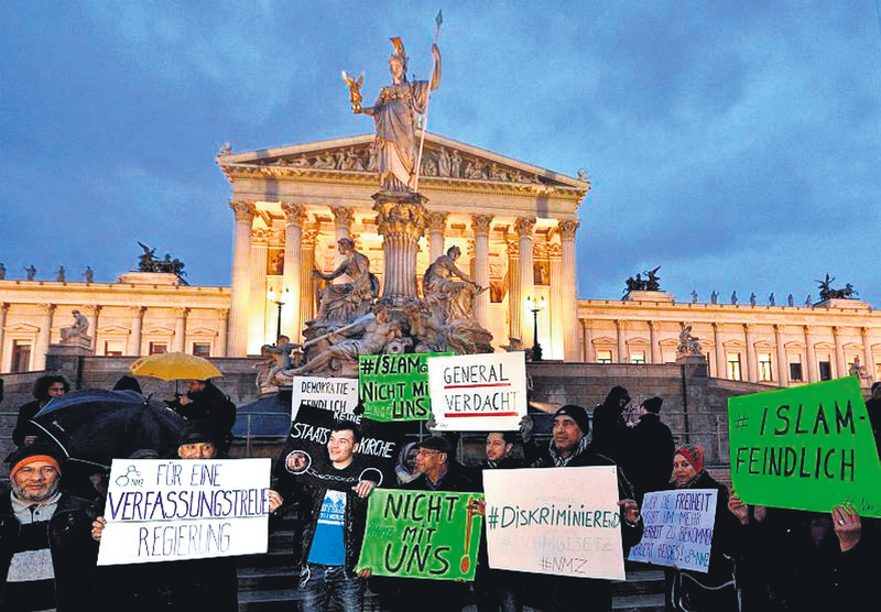 Protesters hold banners during the demonstration under the slogan ,New Islam Law? Not with us!, in front of the parliament building in Vienna, Austria, Feb. 24.