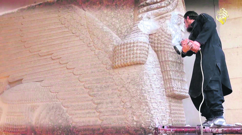 A militant attempts to damage the ancient statue.