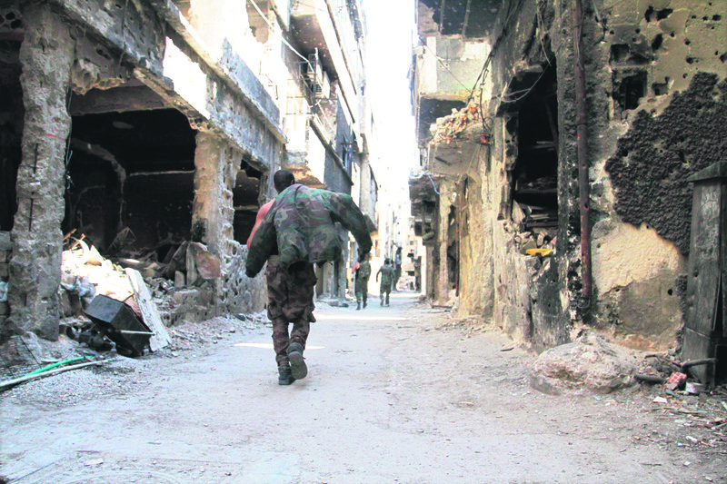 A man walks through the ruined streets of the Yarmouk refugee camp.