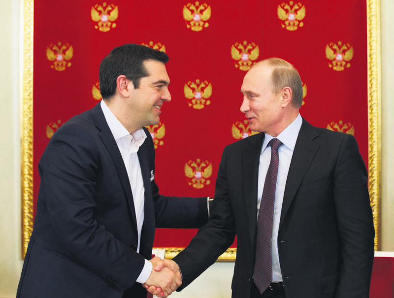 Greek Prime Minister Tsipras (L) shakes hands with Russian President Putin during a signing ceremony at the Kremlin in Moscow on Wednesday.