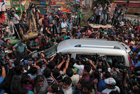Journalists surround the car carrying family members of Mohammad Qamaruzzaman, as they leave the Central Jail after meeting Qamaruzzaman in Dhaka, Bangladesh AP Photo
