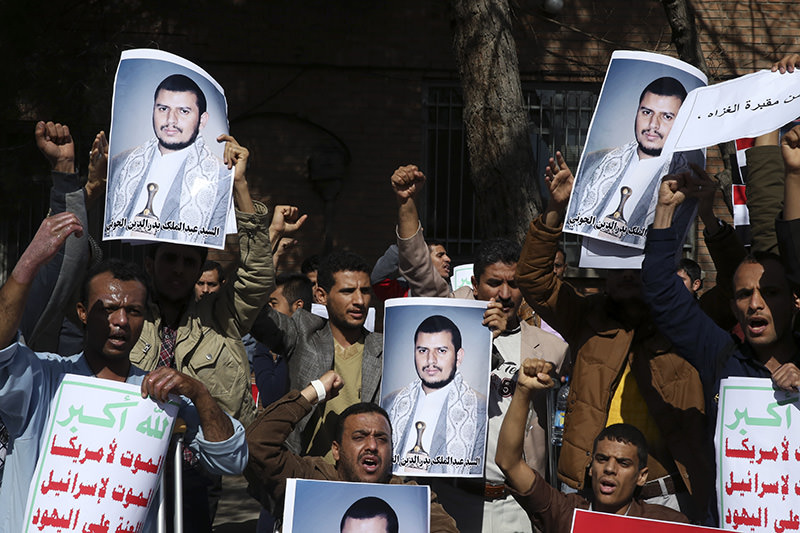 Yemeni men, among them some injured in violence in Yemen, chant slogans while holding posters of Shiite Houthi rebel leader Abdul-Malik al-Houthi (AP Photo)