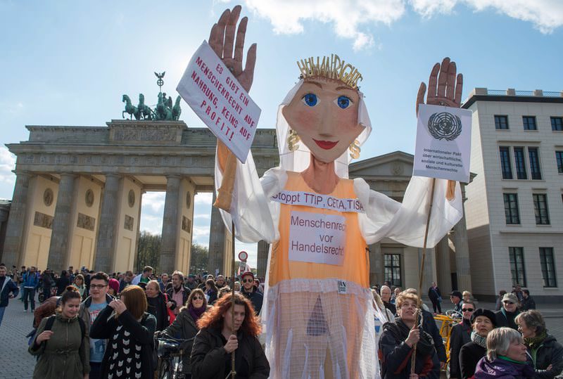 Protesters participate in a demonstration against the planned free trade agreement TTIP between the European Union and the USA in Berlin, Germany, 18 April 2015 (DPA Photo)