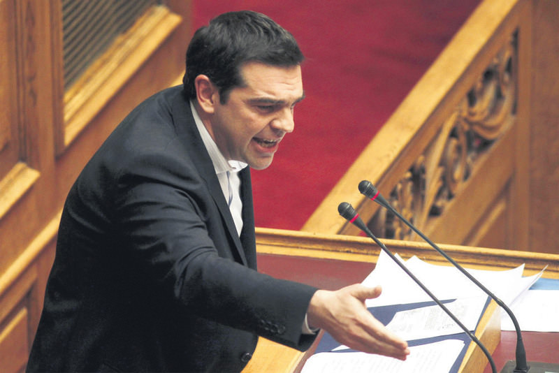 Greek PM Tsipras delivers a speech during a plenary session of parliament in Athens. Tsipras called on local governments to keep their funds in the central bank.