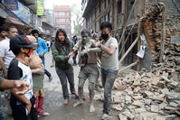People free a man from the rubble of a destroyed building after an earthquake hit Nepal, in Kathmandu, Nepal, 25 April 2015 (EPA Photo)