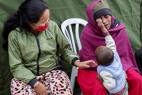 Jamna Pariar, 22, is comforted by her son after she learnt about the death of her nine-day-old daughter at the Israel Defence Forces (IDF) field hospital, following Saturday's earthquake in Kathmandu, Nepal (Reuters)
