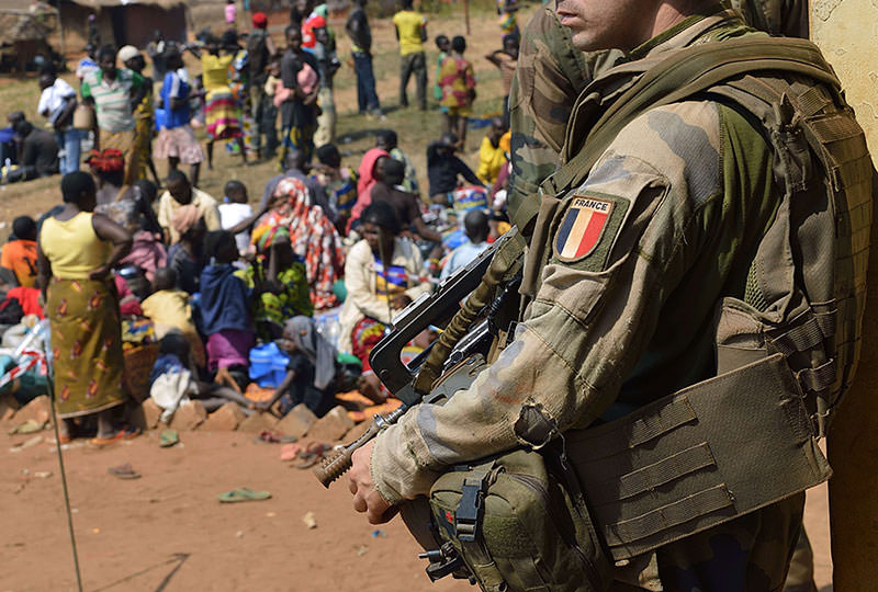 A French soldier taking part in 'Operation Sangaris' standing guard as Muslim people wait to seek refuge at the Boali church, in Boali, some 100km north of Bangui (AFP Photo)