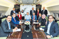 Prisedent Erdou011fan (center) on the Presidential Plane, speaking to journalists, including Daily Sabah Editor-in-Chief Serdar Karagu00f6z (first on right), on his return flight from Europe. 