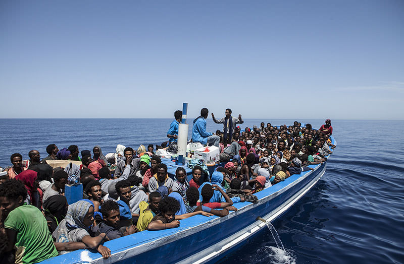 This handout picture taken on May 3, 2015 released by the MOAS (Migrant Offshore Aid Station) shows migrants aboard a wooden boat on the Mediterranean Sea (AFP Photo)
