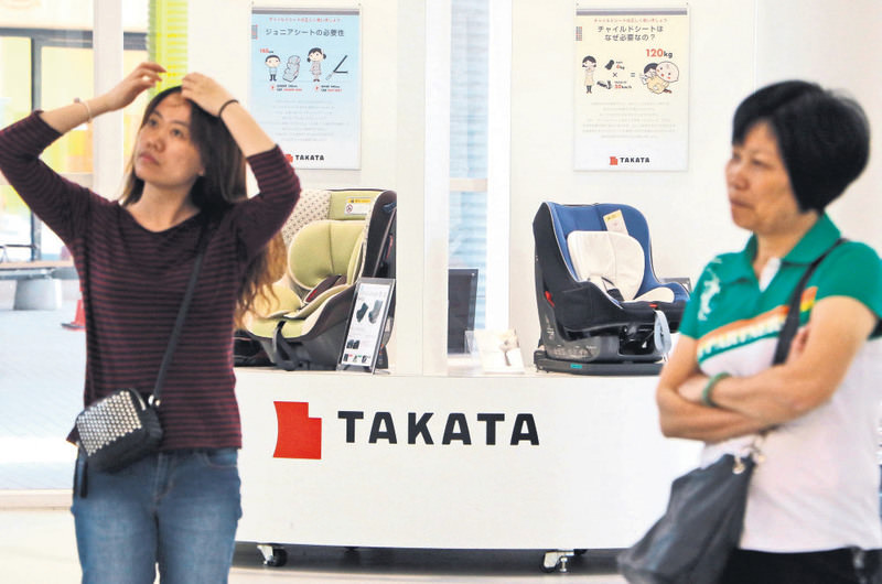 Japanese auto parts maker Takata's child car seats are displayed at a showroom in Tokyo yesterday. Takata is doubling a recall of US cars with potentially deadly airbags to a record nearly 34 million vehicles.