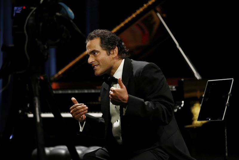 Syrian-American pianist and composer, Malek Jandali gestures on stage on May 16, 2015 in Dubai. 