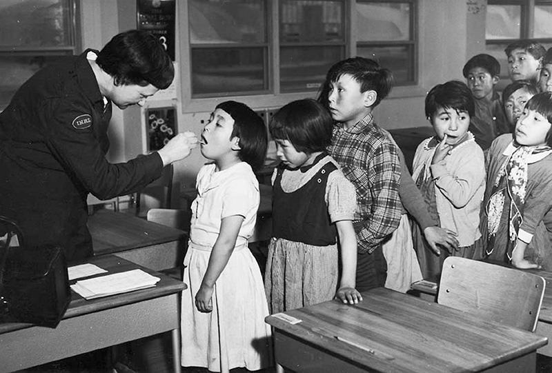 Nurse Desrochers checks a girl's throat while other children wait in line, at the Frobish Bay Federal Hostel in Nunavut, Canada in a 1959 archive photo (Reuters)