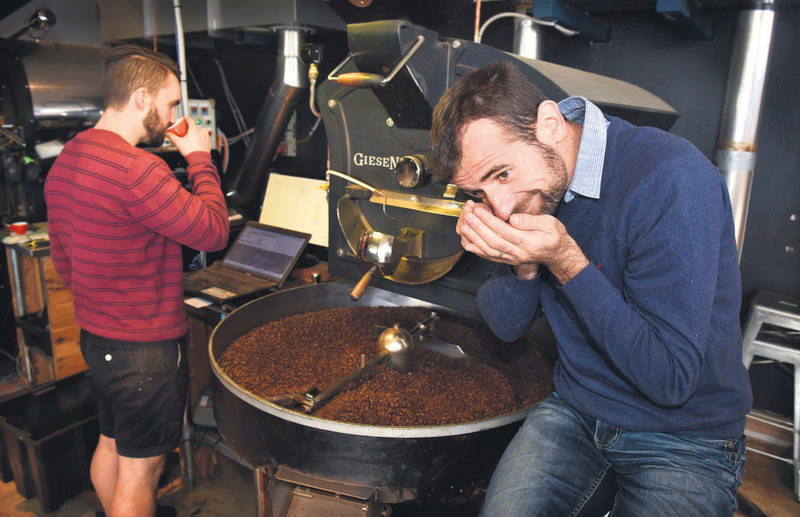 Coffee maker and cafu00e9 owner Sasa Sestic (R) at his roasting facility in Australia's capital Canberra.He won the World Barista Championship this year.