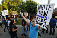 Todd Whitley, center, of Hope for Peace and Justice showed his support for protestors that marched outside the Craig Ranch pool Monday, June 8, 2015. (AP Photo)