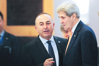 Foreign Minister Mevlu00fct u00c7avuu015fou011flu talks with U.S. Secretary of State John Kerry at a NATO meeting in Antalya on May 13, 2015.