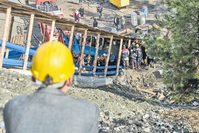 All 18 miners were trapped hundreds of meters below the surface when a sudden flood of water from an old, adjacent mine quickly inundated the galleries. It took weeks to recover all the bodies.