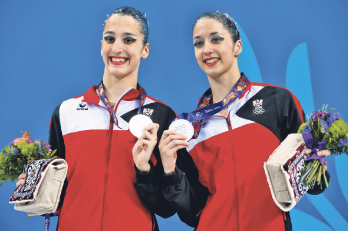 Eirini-Marina, left, and Anna-Maria Alexandri of Austria, celebrate their second place at the final of synchronised swimming.