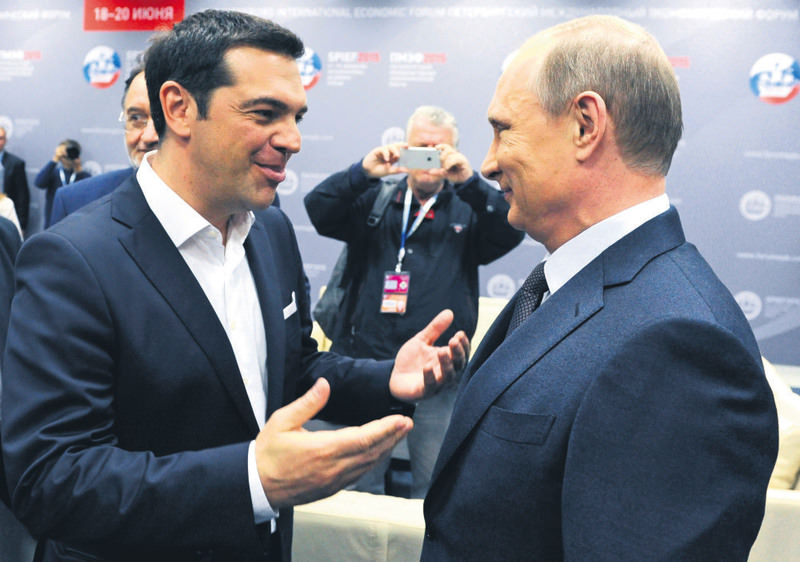 Greek PM Tsipras (L) and Russian President Putin speak at an economic forum in St. Petersburg on Friday. Russia and Greece agreed on extending the Turkish Stream pipeline project to Greek territory.