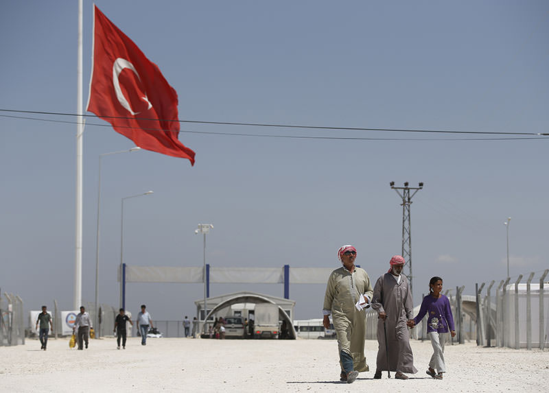 Syrian refugees walk at a refugee camp in Suruu00e7, on the Turkey-Syria border, Friday, June 19, 2015. Ahead of World Refugee Day on Saturday, June 20, 2015 (AP Photo)