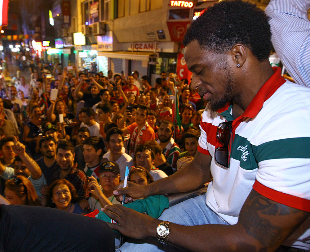 Bobby Dixon, MVP of the final series, signs a fan's shirt during celebrations on Saturday night