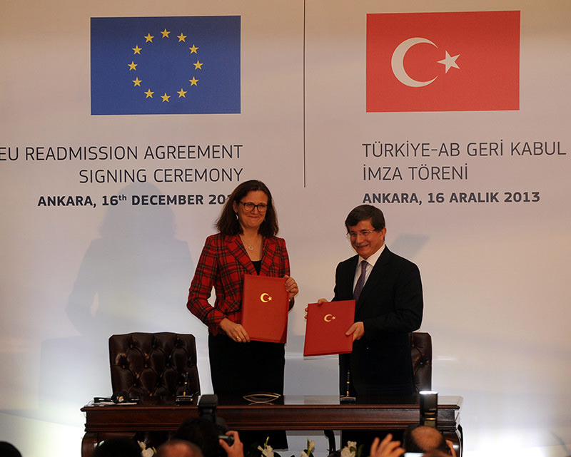 European home affairs Commissioner, Cecilia Malmstrom, Turkeyu2019s then Foreign Minister Ahmet Davutou011flu signing readmission agreement for Turkish citizens in Belgium, Dec. 04, 2013
