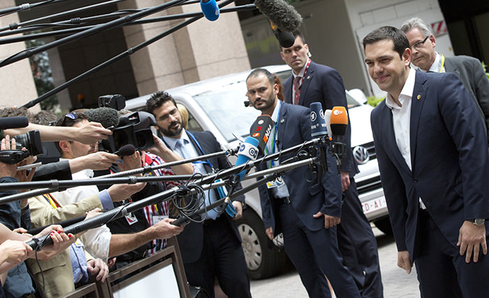 Greek Prime Minister Alexis Tsipras speaks with the media as he arrives for an EU summit in Brussels on Thursday, June 25, 2015 (AP Photo)
