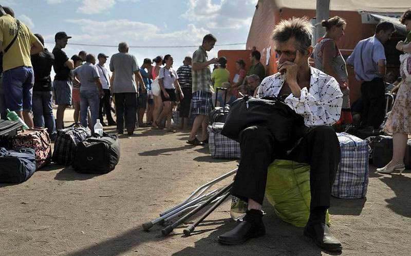 Refugees from southeastern Ukraine wait after arriving at a refugee camp in the Russian border town of Donetsk near Rostov Oblast.