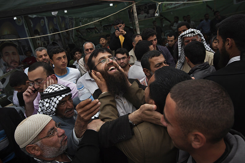 In this April 18, 2012 file photo, Palestinian Khader Adnan, center, is greeted by Palestinians during a celebration ceremony after his release from Israeli jails, in the West Bank village of Arrabeh (AP Photo)