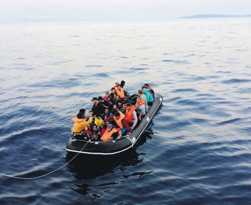 Migrants rescued by the Turkish Coast Guard huddle in a boat. Illegal immigrants, mainly from the Middle East, risk their lives every day to reach Europe on the Aegean Sea.