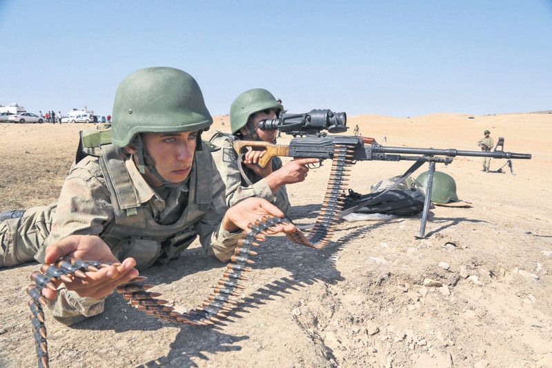 Turkish soldiers take position a few hundreds meters from the border in Muru015fitpu0131nar near Suruu00e7, as fighting intensifies between Syrian Kurdish forces and ISIS.