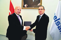 ASELSAN CEO Faik Eken (L), and Turkcell CEO Kaan Terziou011flu (R) shaking hands to formalize the collaboration in 5th generation mobile communication and network technologies