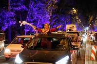 Iranians celebrate in the streets of Tehran, Iran, after nuclear talks between Iran and the six powers ended in Vienna.