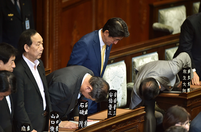 Japan's Prime Minister Shinzo Abe (3rd R) and his cabinet members react after passing controversial security bills during a lower house plenary session at the parliament in Tokyo (AFP Photo)