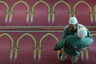 Nepalese Muslim devotees hug after offering early morning Eid al-Fitr prayers at Kashmiri Mosque in Kathmandu. 