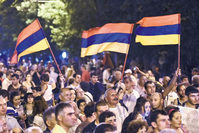 Protesters wave Armenian national flags during a rally against a hike in electricity prices in Yerevan, Armenia.