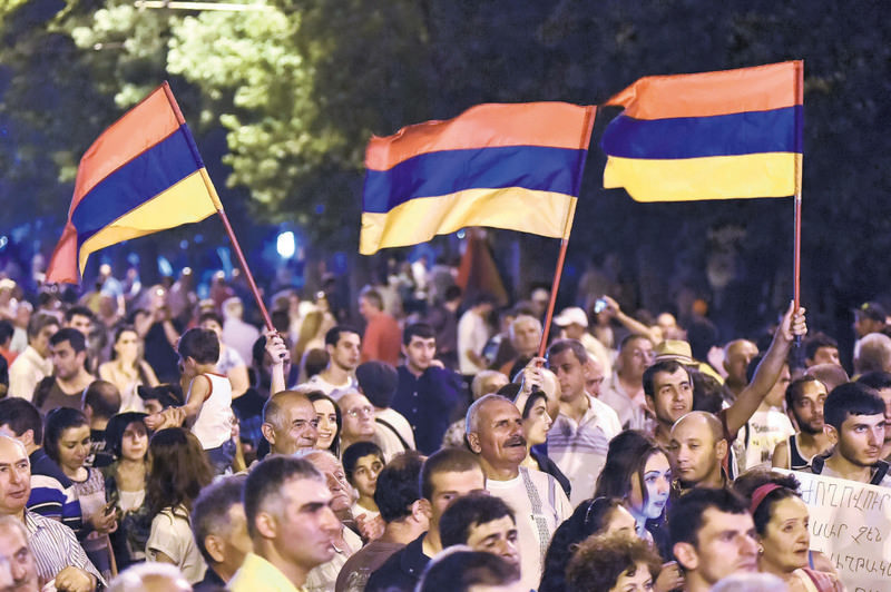 Protesters wave Armenian national flags during a rally against a hike in electricity prices in Yerevan, Armenia.