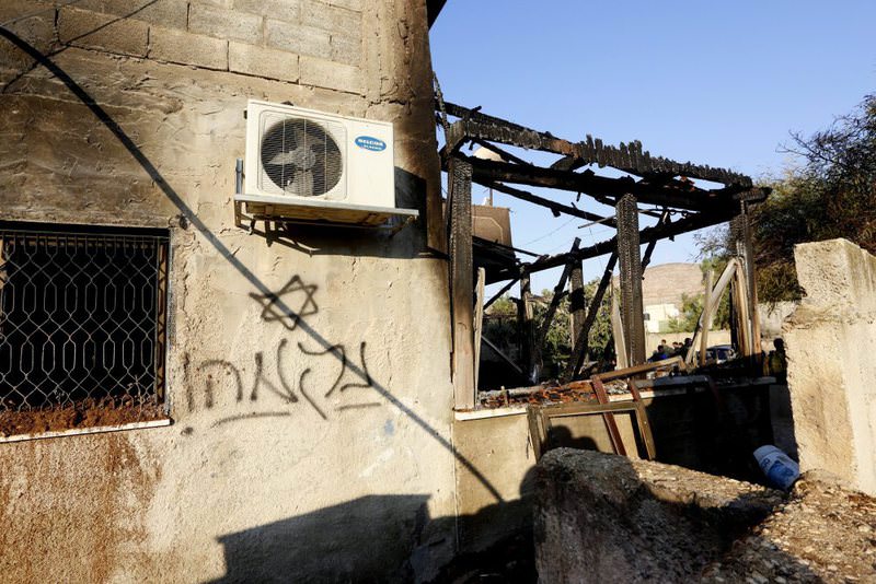 Graffiti reading in Hebrew ,revenge, seen on the wall of the fire damaged house in the West Bank village of Duma near Nablus City 