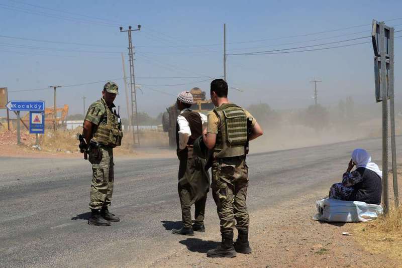 Turkish soldiers wait at a checkpoint in Diyarbaku0131r on July 26, 2015 following the death of two Turkish soldiers.