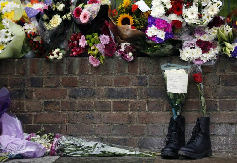 A pair of army boost with bouquets for Lee Rugby, who was killed by two Muslim converts of Nigerian descent in retribution for Muslim deaths. The attackers were allegedly contacted by MI6.