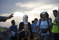 Migrants and refugees walk to board an Athens-bound ferry at the southeastern island of Kos, Greece, Friday, Aug. 14, 2015 (AP photo)