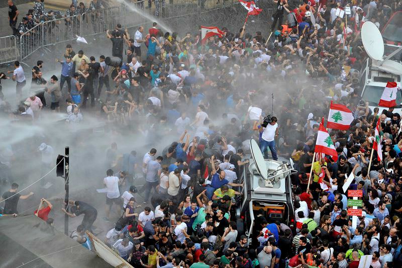 Lebanese security services use water cannons to disperse activists trying to remove barbed wire blocking the entrance to the Lebanese Government Palace.  