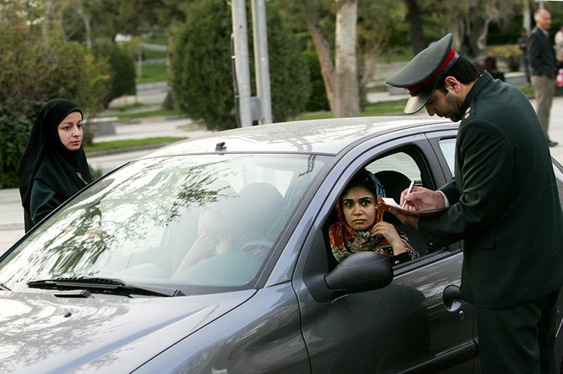 A file picture taken on April 22, 2007 shows Iranian police officers stopping a car during a crackdown to enforce the dress code in the north of Tehran (AFP photo).