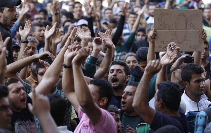 Migrants shout slogans in front of the Keleti Railway Station in Budapest, Hungary.