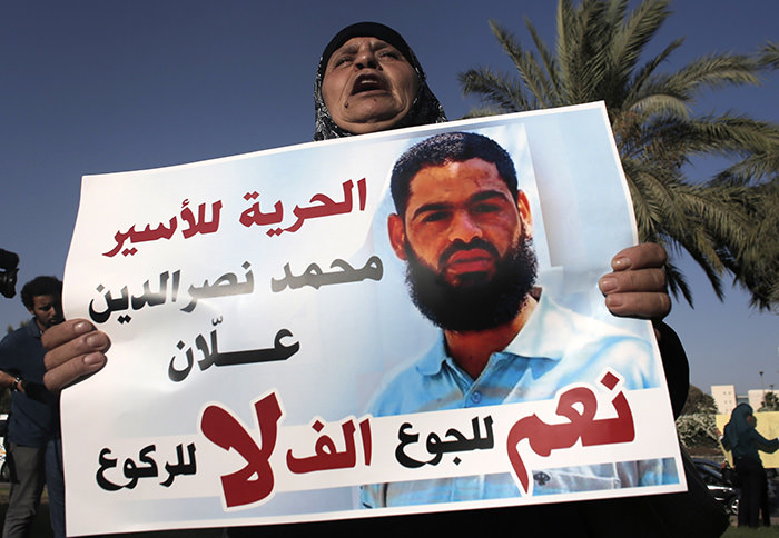 Maazouze, the mother of Mohammed Allaan holds a portrait of her son during a rally calling for his release in the southern Israeli city of Beersheva on August 9, 2015 (AFP Photo)