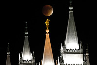Earth's shadow obscures the view of a so-called supermoon during a lunar eclipse over the LDS Temple in Salt Lake City, Utah, Sunday, Sept. 27, 2015 (AP Photo)