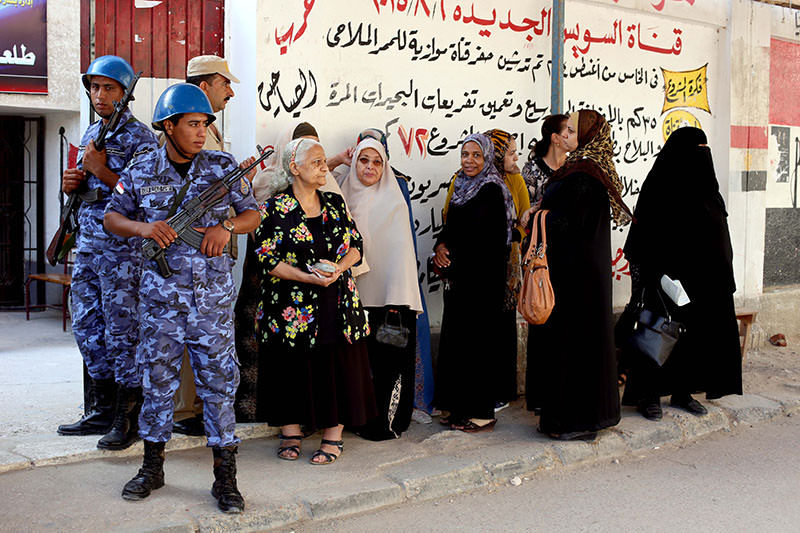 Voters wait to cast their votes outside a polling station during the first round of the parliamentary elections, in Behira, north of Cairo, Egypt, Sunday, Oct. 18, 2015. (AP Photo)