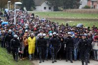 About 1,000 migrants are escorted by Slovenian police from the border crossing with Croatia .