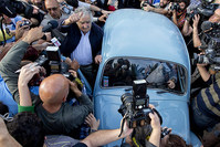 Uruguay's President Jose Mujica, center, leaves after casting his vote during general elections in Montevideo, Uruguay Sunday, Oct. 26, 2014 (AP Photo)