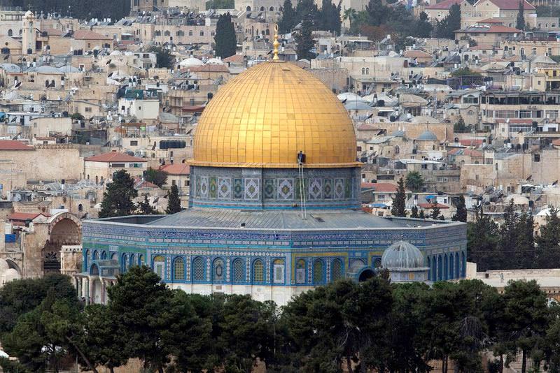 A man stands on a ladder on the roof of the Dome of the Rock at the Muslims' holy site Haram al-Sharif and known as the Temple Mount to Jews in Jerusalem.