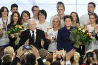 Conservative Law and Justice Party leader Jaroslaw Kaczynski (L) along with the Party's candidate for prime minister, Beata Szydlo (R) deliver a speech at the party's headquarters in Warsaw.